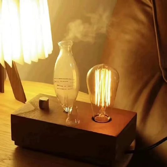 Vintage style aroma diffuser with tungsten filament lamp and wooden base emitting mist for aromatherapy